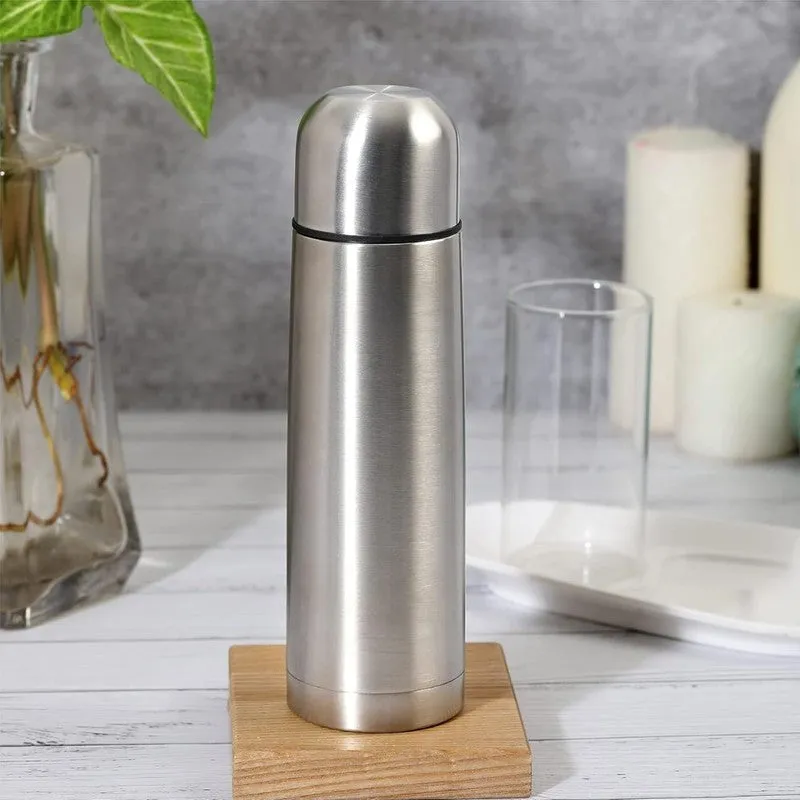 Silver steel bottle standing on a wooden block