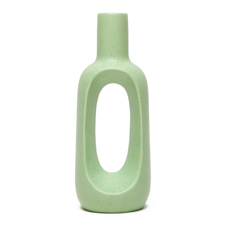 Front view of a green speckled ceramic donut vase