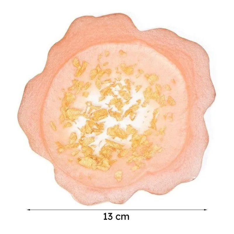 Single peach-pink coaster with gold detailing on a white background