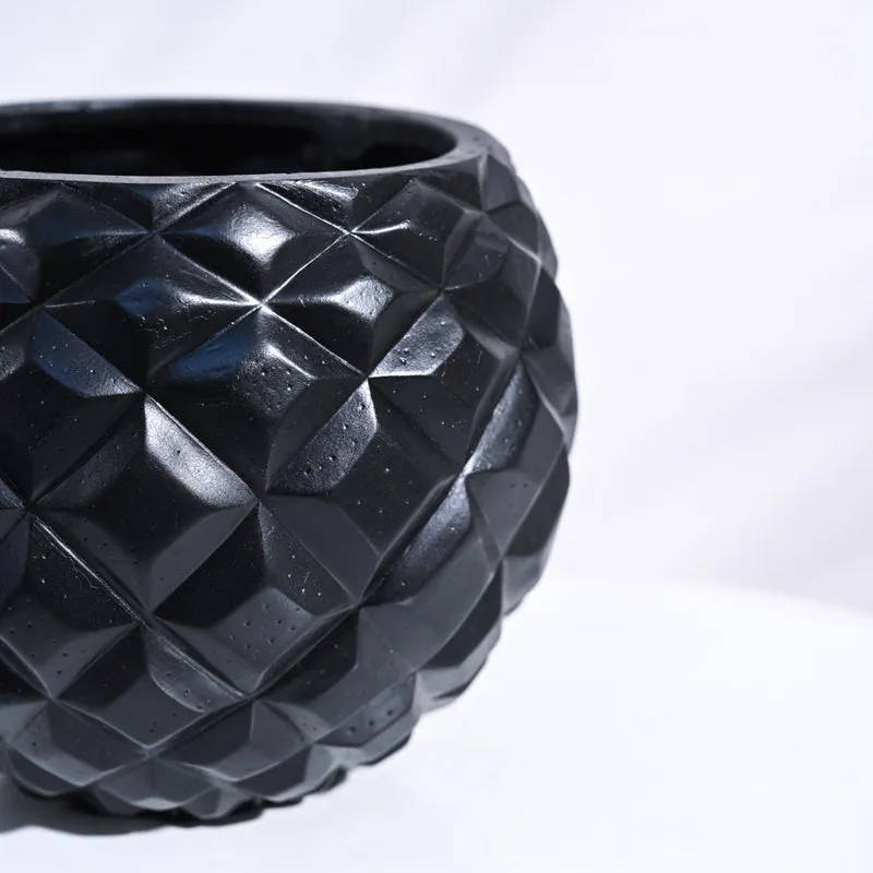 Close-up of the black planter's faceted geometric texture