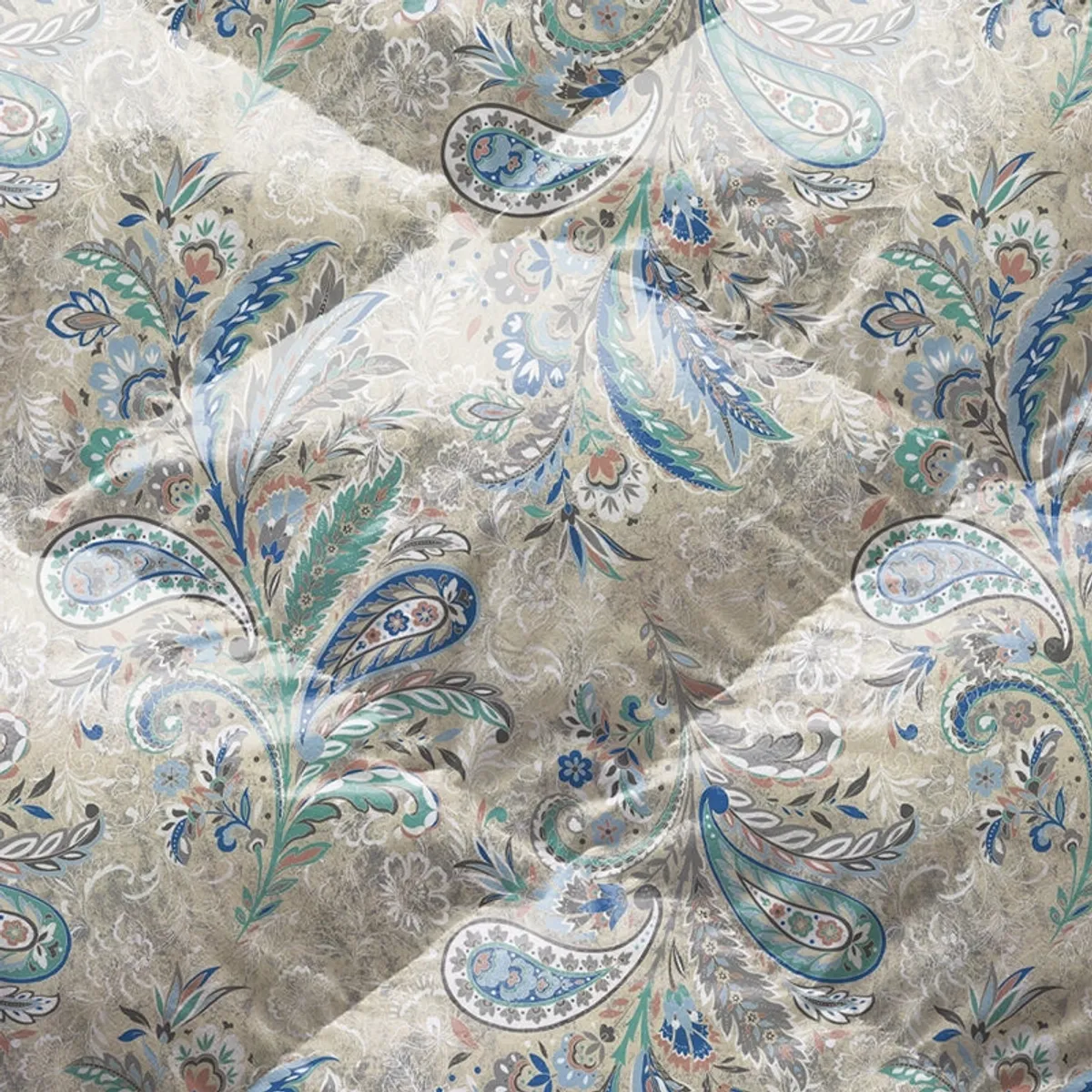 Close-up view of the comforter's detailed ivory, blue and green floral paisley print