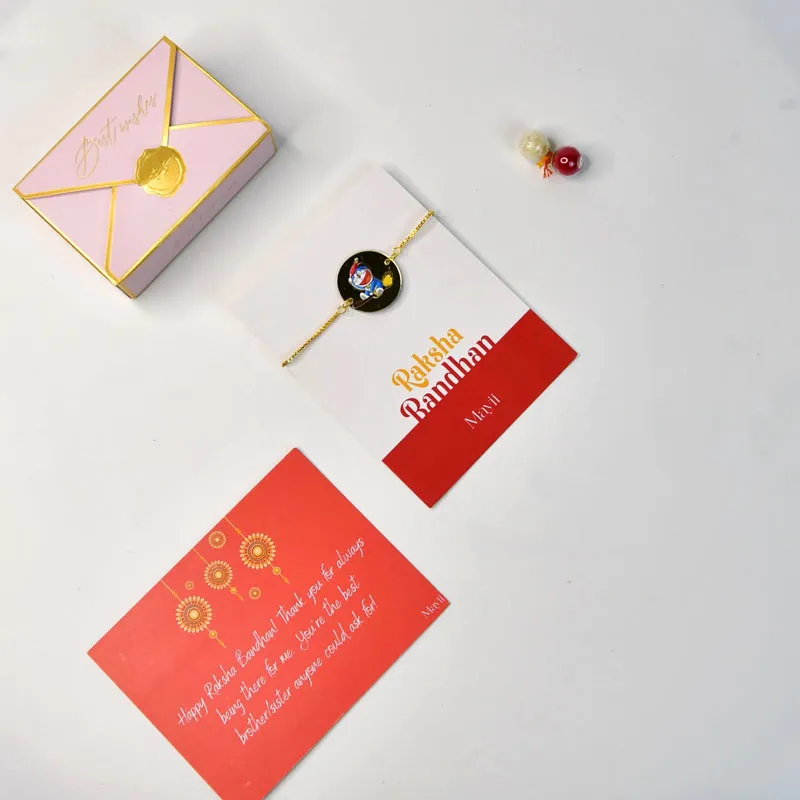Rakhi hamper arranged with a pink box, festive card and rakhi on a white background