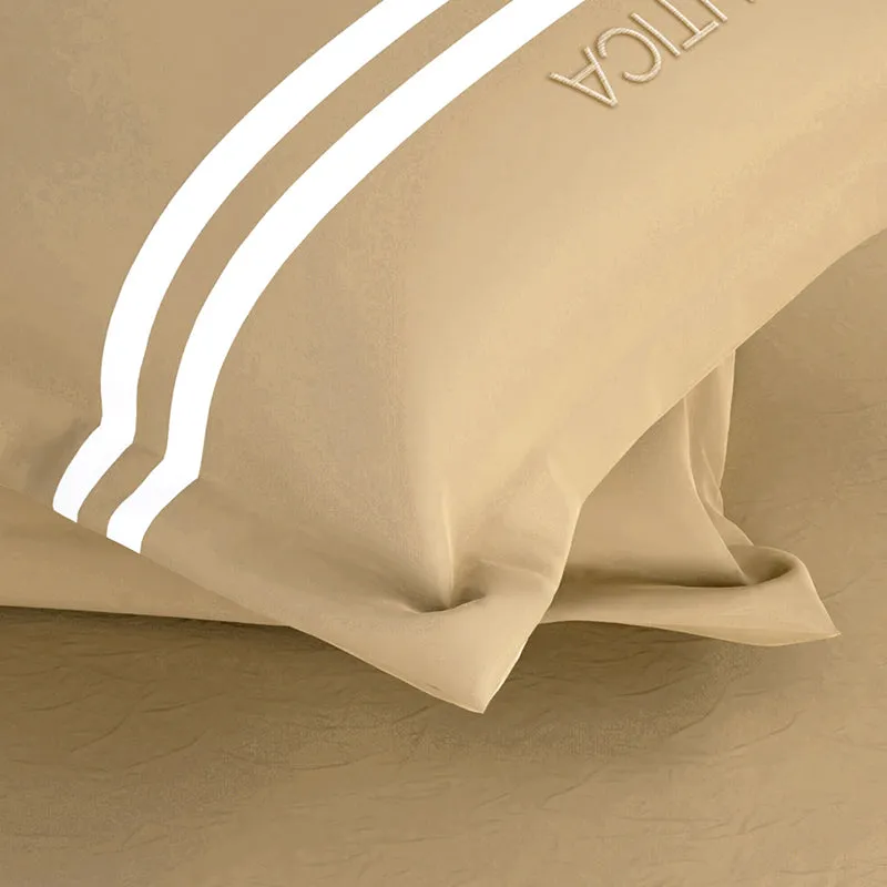 Close-up of tan pillow cover with white stripe detail
