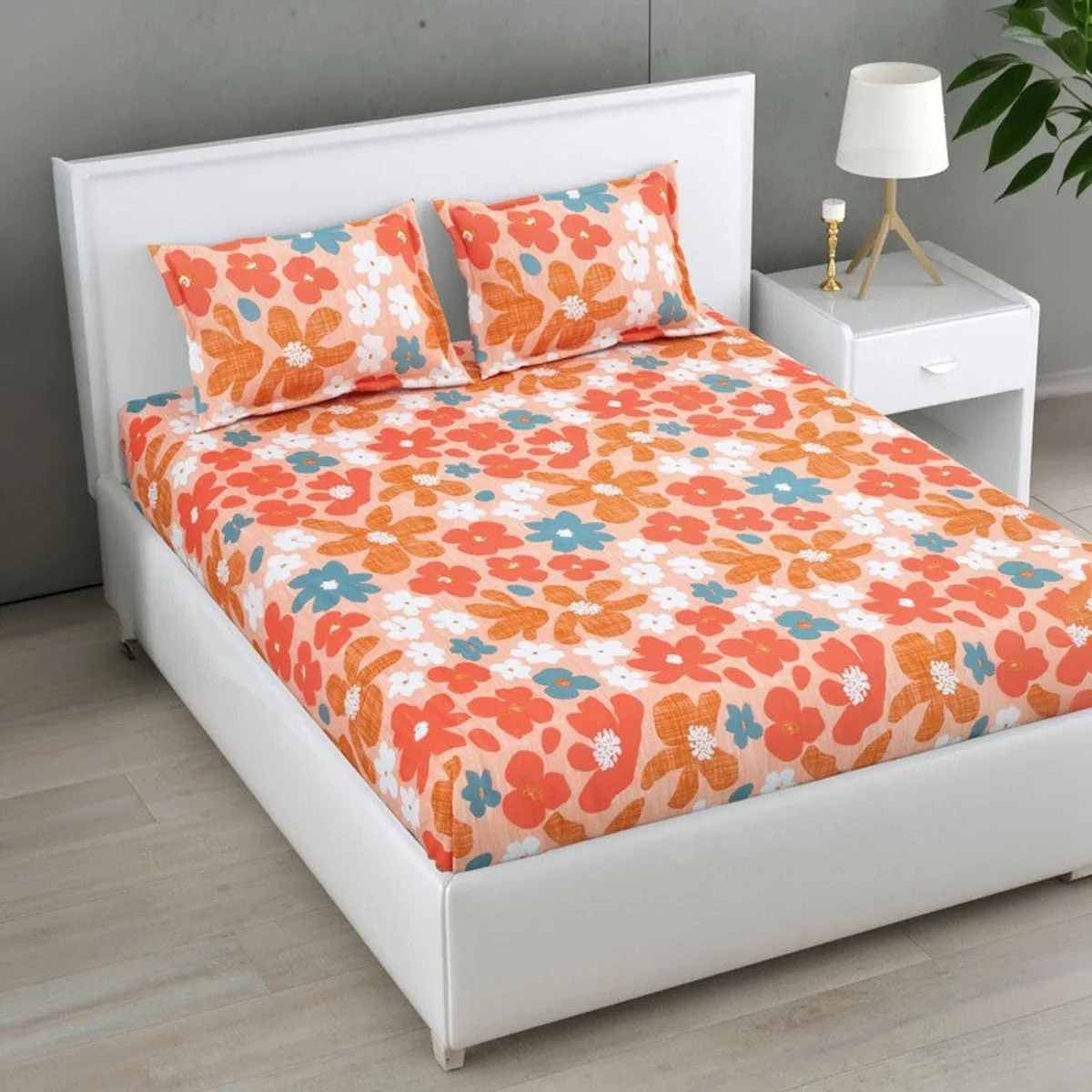 Angled view of a colourful floral cotton bedsheet on a modern bed.