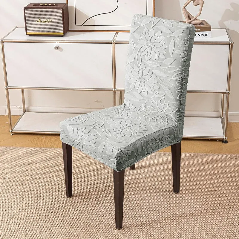 Single grey chair cover with raised floral pattern on a dining chair