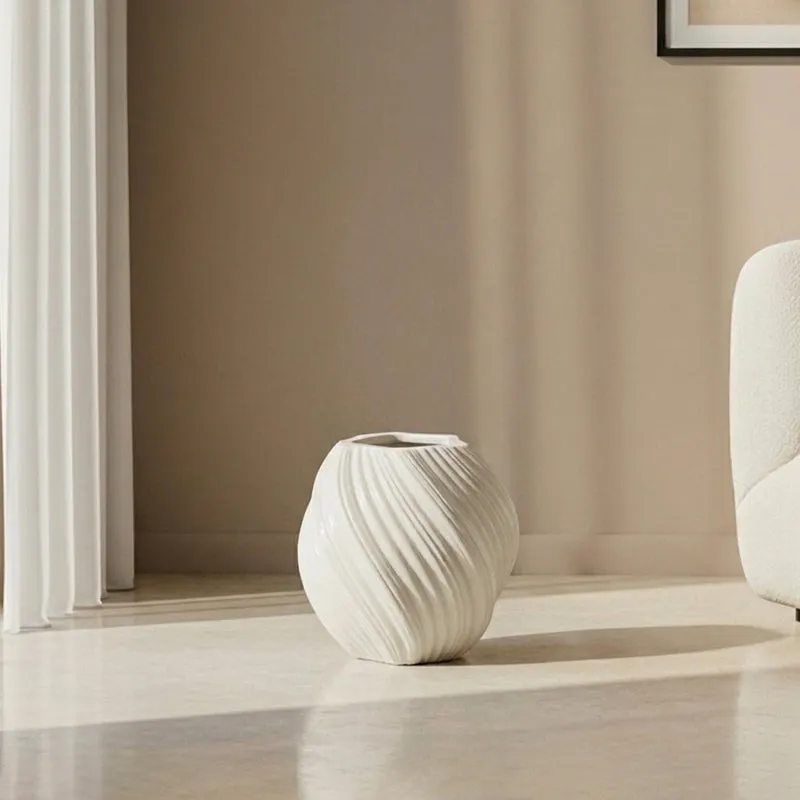 White ribbed round planter shown empty on a light floor