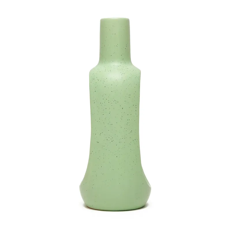 Back view of a green speckled ceramic vase