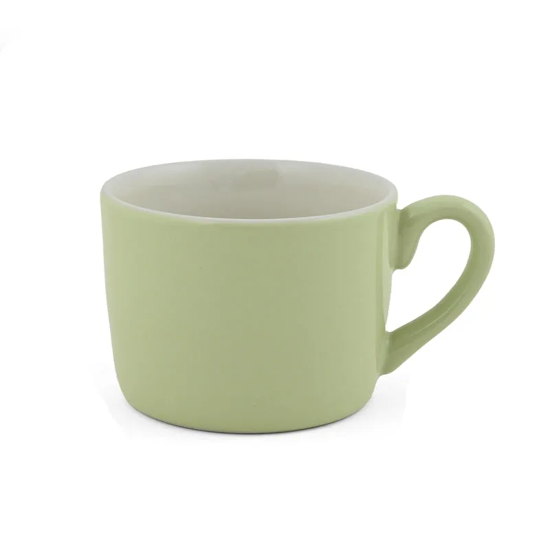 Close-up of a green porcelain cup with a curved handle