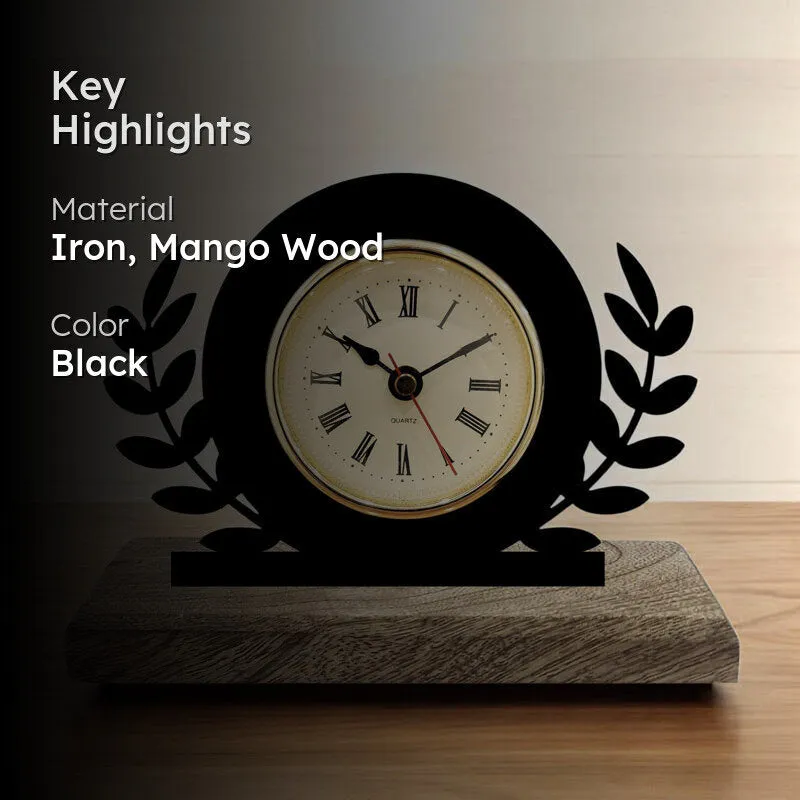 Black laurel design table clock on wooden base with cream dial