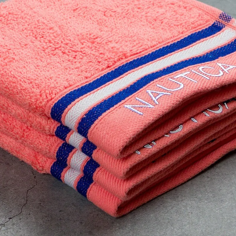 Folded orange towels showing plush texture and striped border