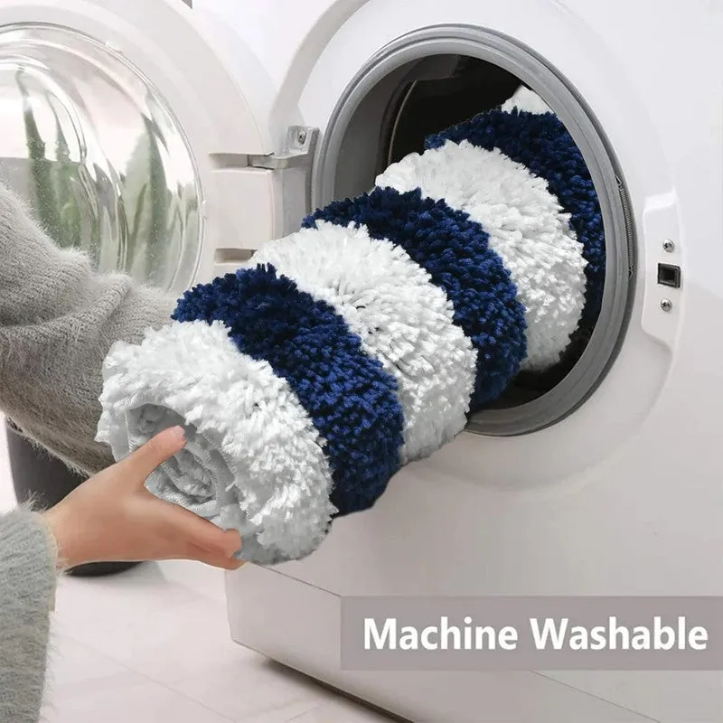 Blue and white striped bath mat being placed into a washing machine