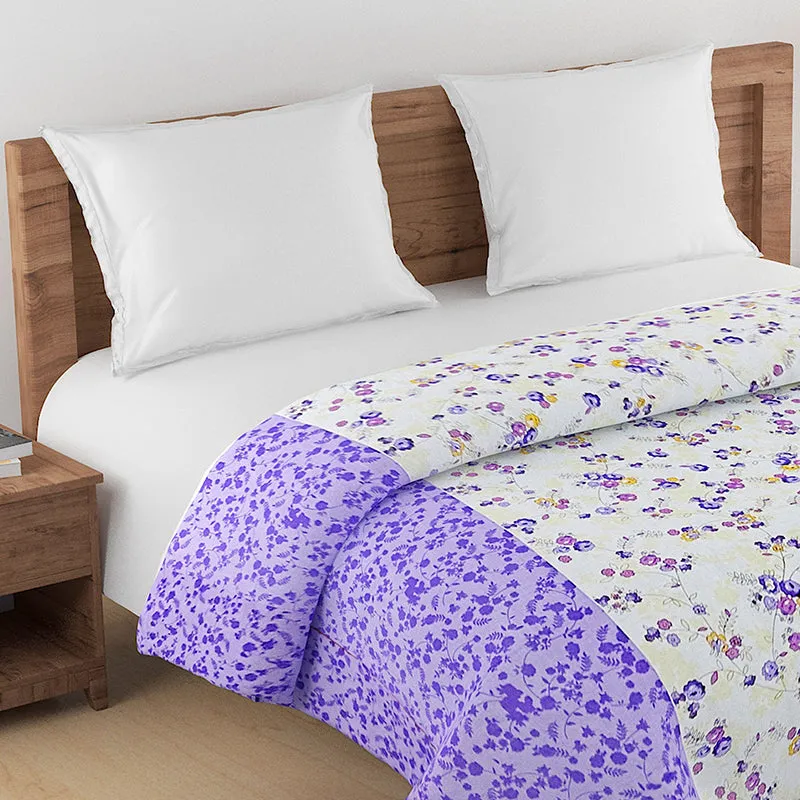 Close view of the purple floral comforter spread across a bed