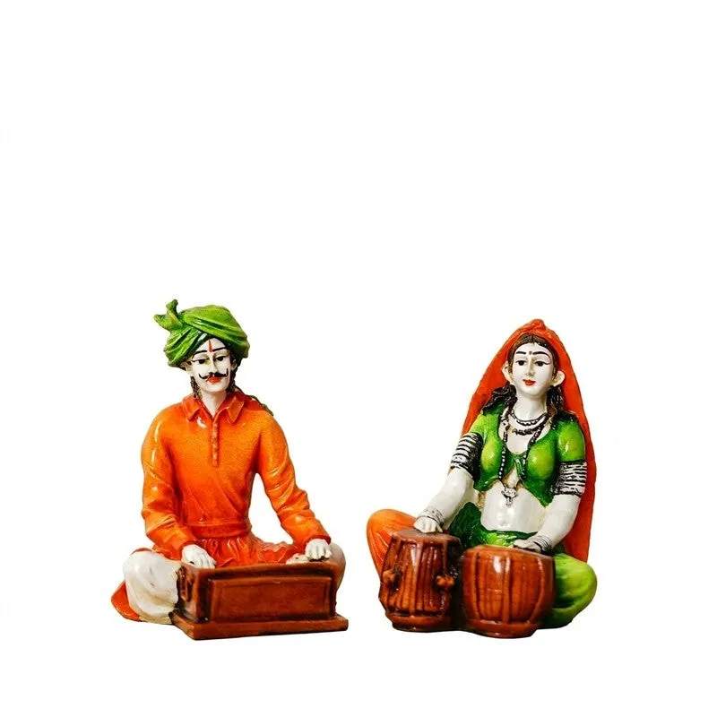 Set of two Rajasthani musician figurines on a white background