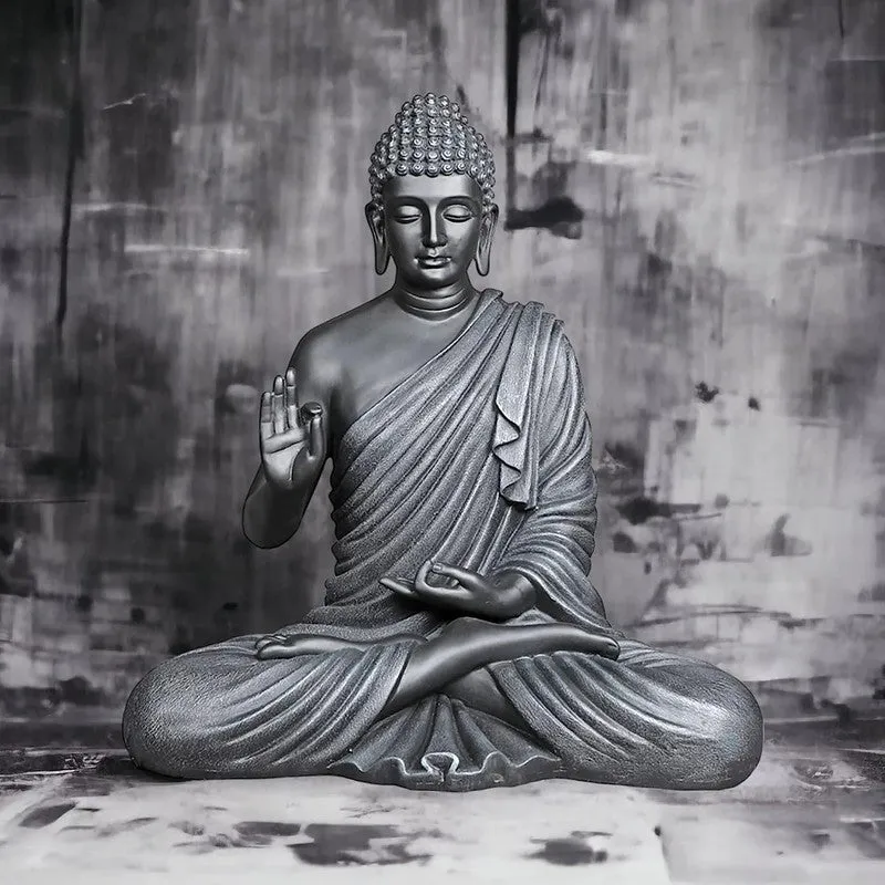 Front view of a grey Buddha idol in a meditative seated pose