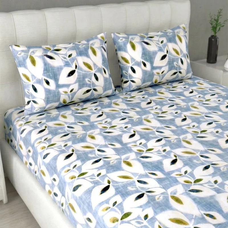 Close view of blue bedsheet with white leaf print and matching pillow covers