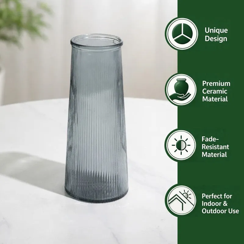 Grey fluted glass vase on table with graphic icons beside it