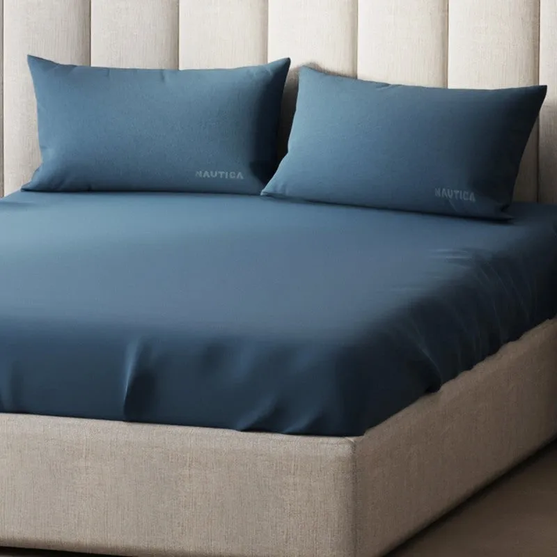 Close view of blue solid bedsheet with two matching pillow covers
