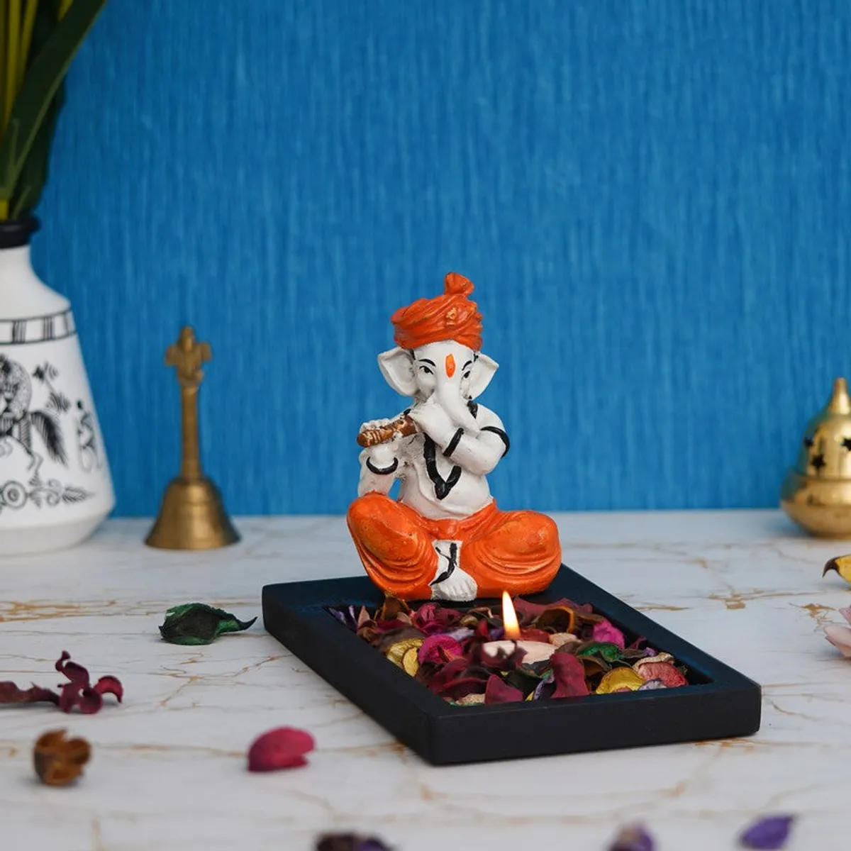 Front view of Ganesha tea light holder with orange and white figurine