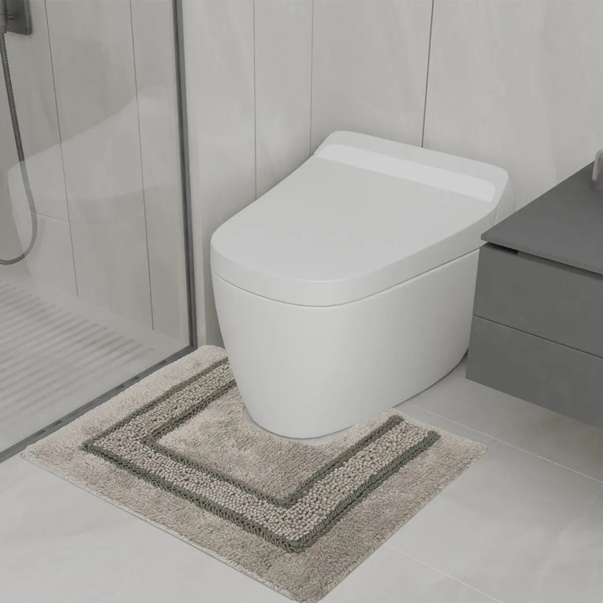 Brown geometric bath mat positioned in front of a white toilet