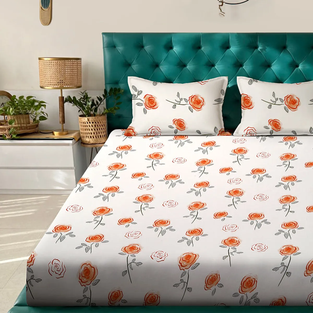 Close view of ivory floral bedsheet and matching pillow covers on a bed