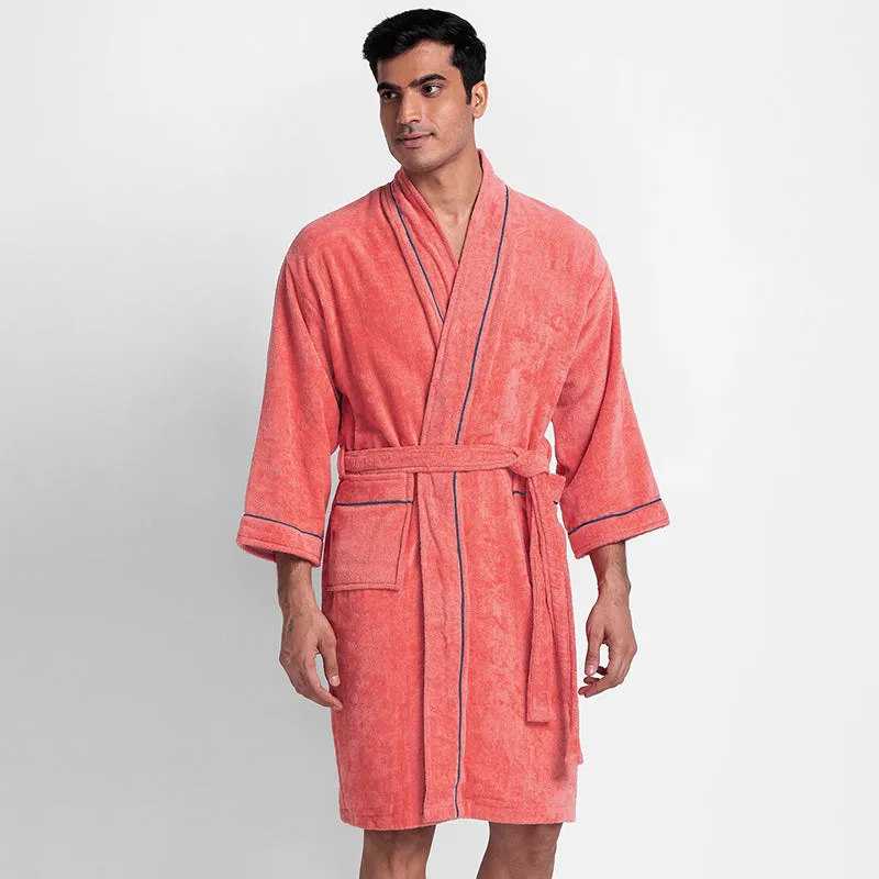 Front view of a peach bath robe with contrast navy piping