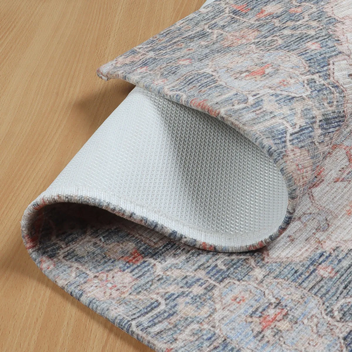 Corner of the doormat lifted to show its white textured underside