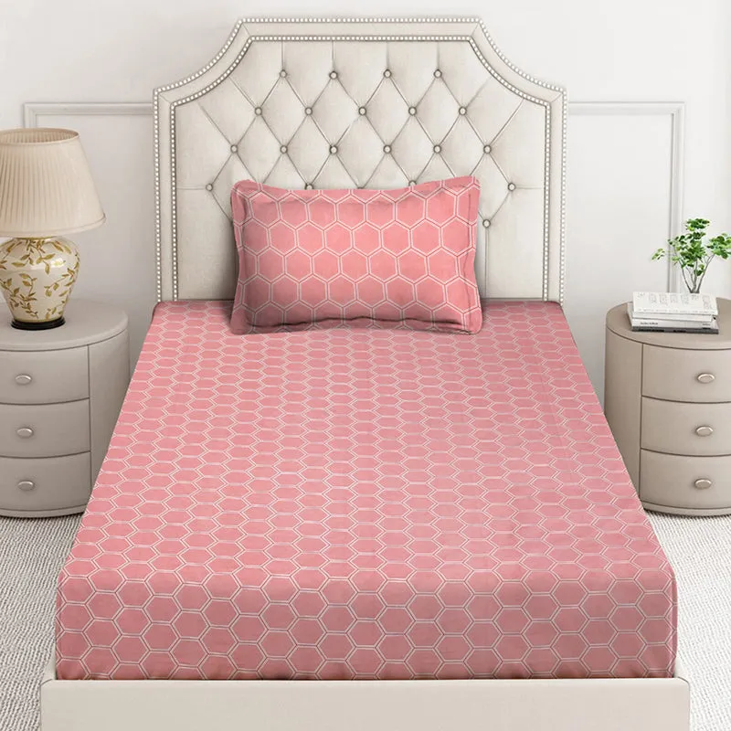 Front view of pink geometric bedsheet with matching pillow cover on bed
