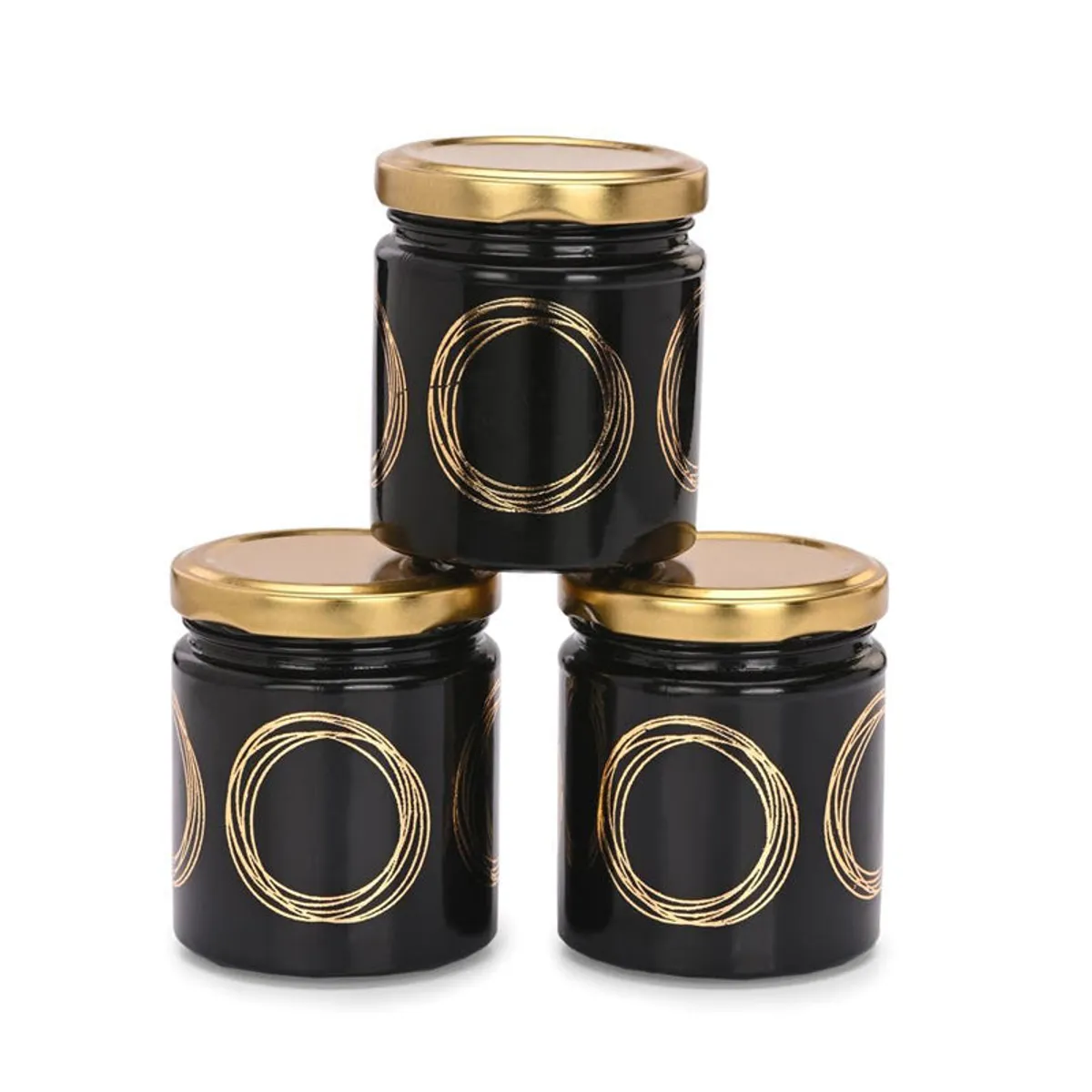 Three black jars with gold circular detailing and lids arranged together on a white background.