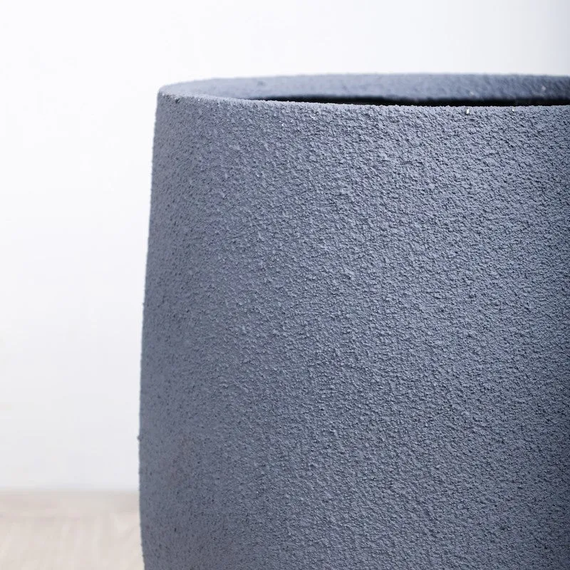 Close-up view of the grey planter rim and textured finish