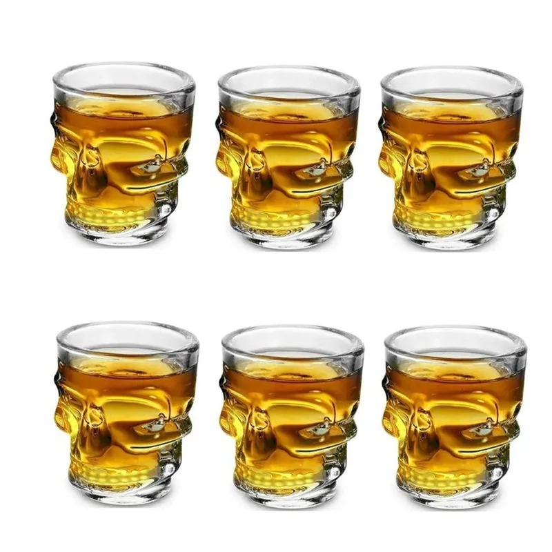 Six clear skull-shaped shot glasses arranged in two rows
