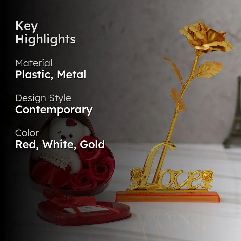 Gold rose ornament and red heart-shaped box in a styled setting