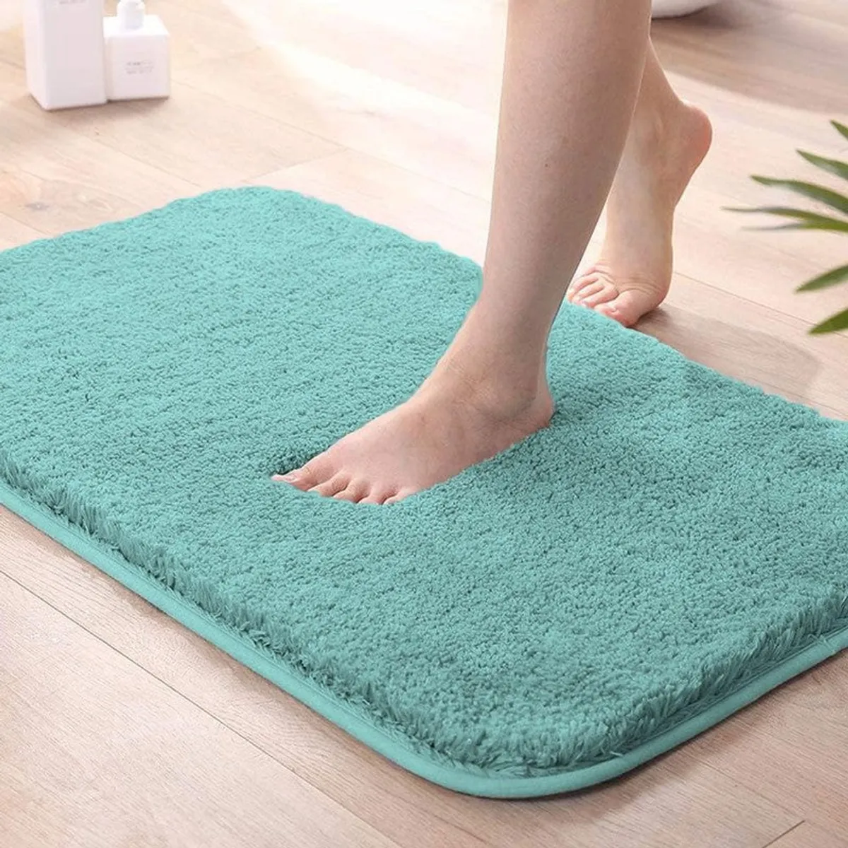 Close-up of sea blue plush bath mat with a soft textured surface