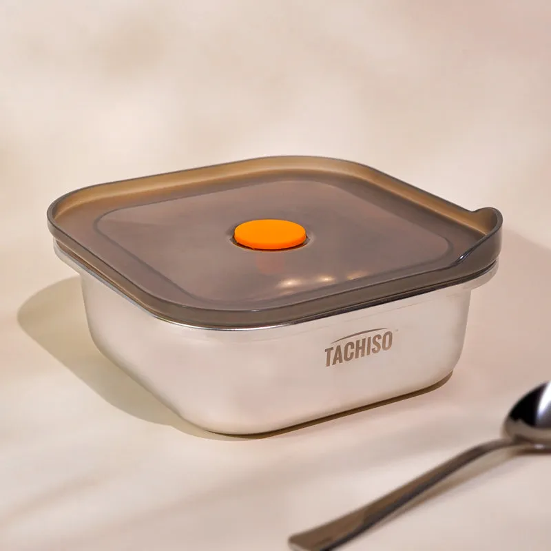 Closed stainless steel storage container with dark lid and orange centre detail