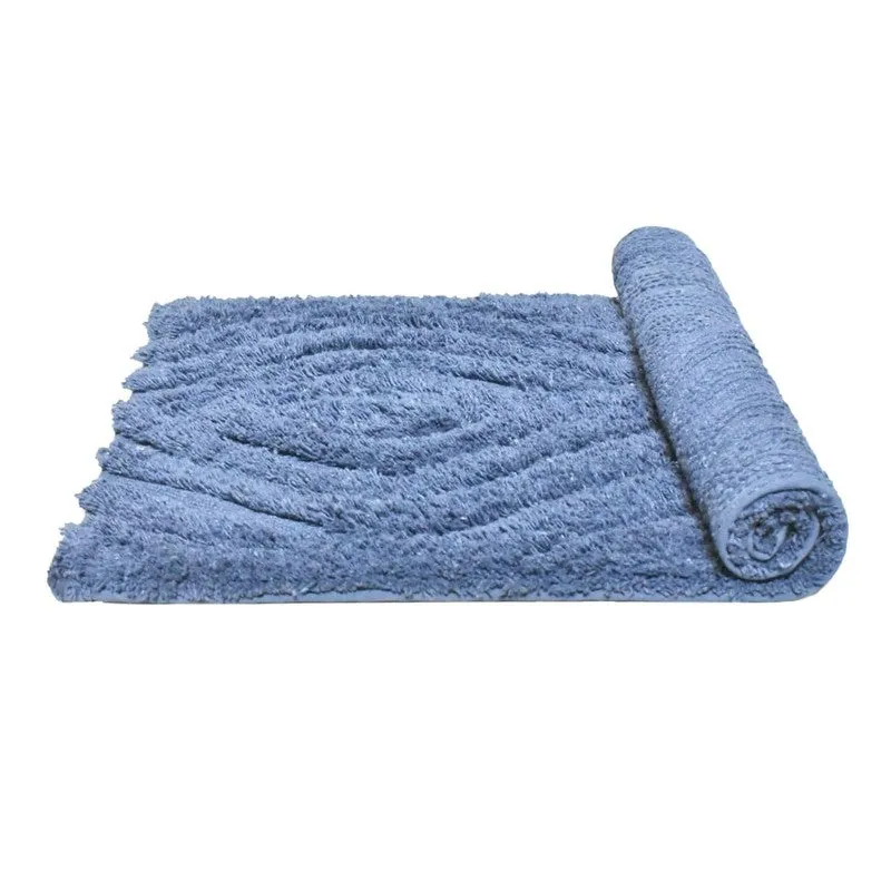 Blue bath mat partially unrolled to reveal its raised geometric texture