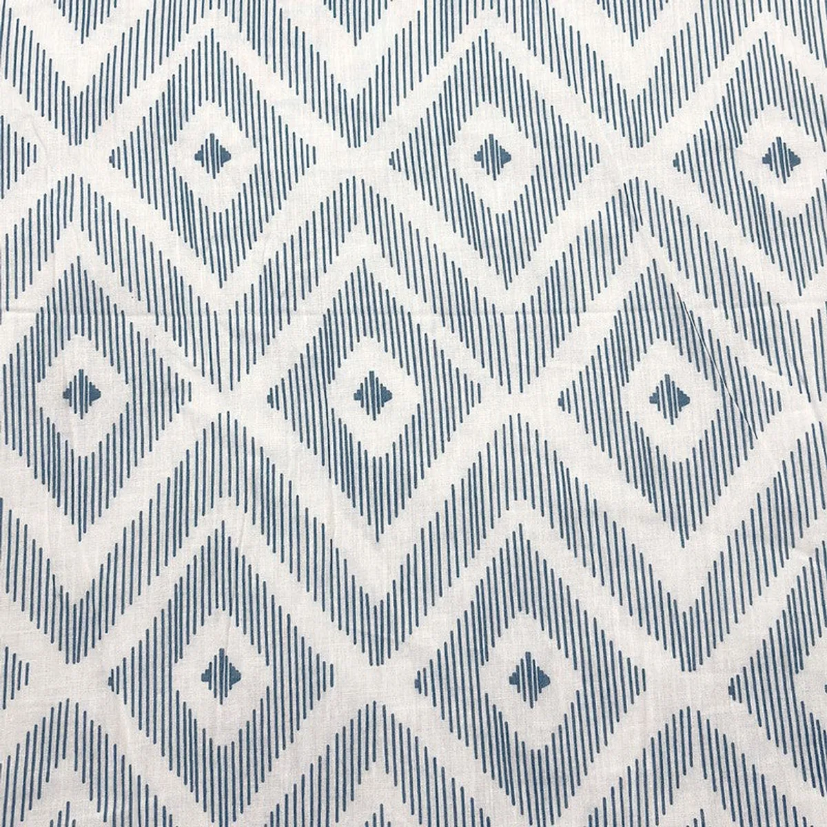 Close-up of blue and off-white diamond geometric pattern