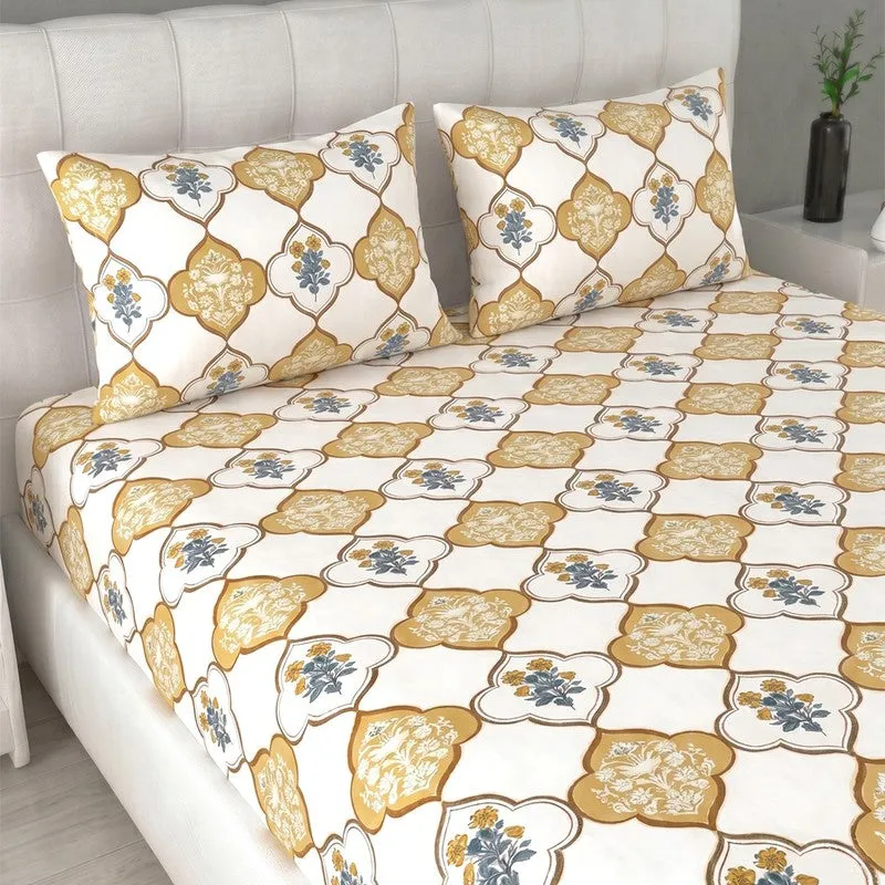 Close view of yellow and off-white printed bedsheet with matching pillow covers