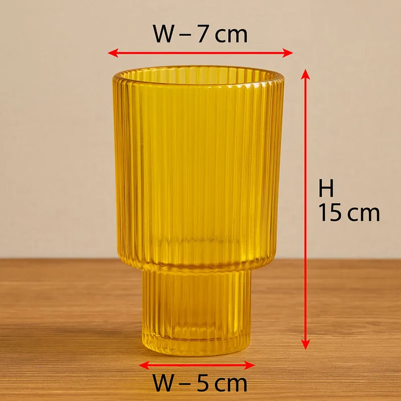 Yellow ribbed glass vase shown front-facing on a wooden surface