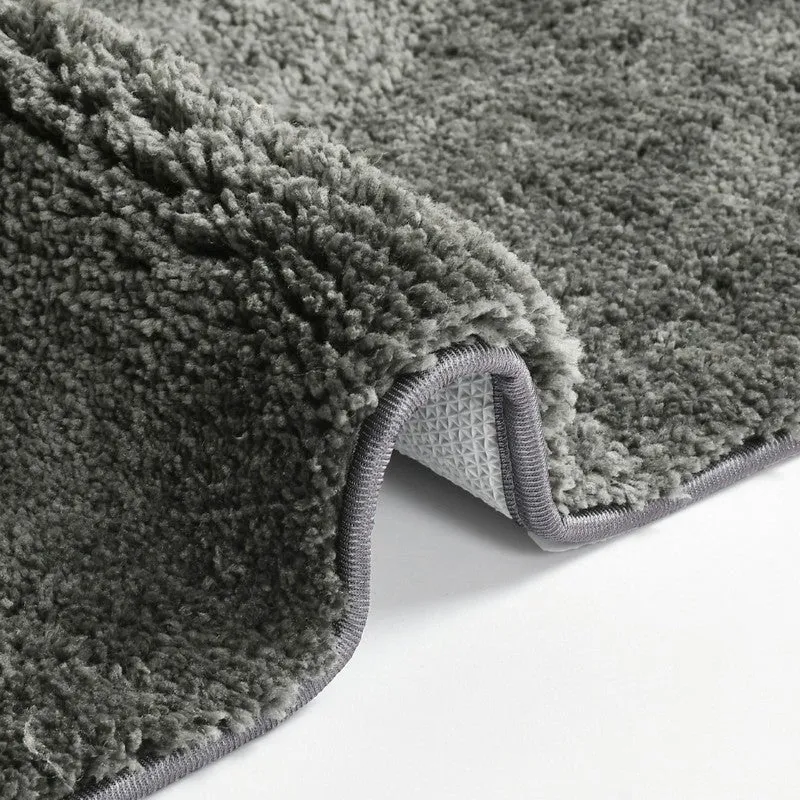 Folded corner of the grey bath mat showing plush pile