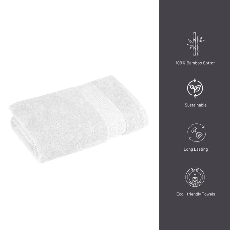 Folded white plush bath towel with a subtle decorative band.