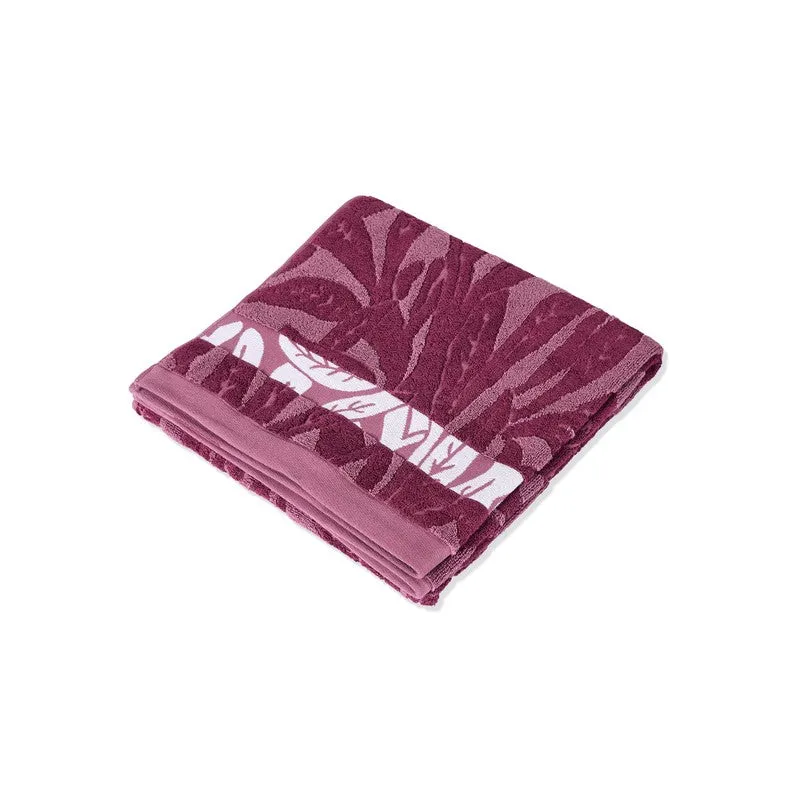 Folded maroon floral bath towel shown against a white background.