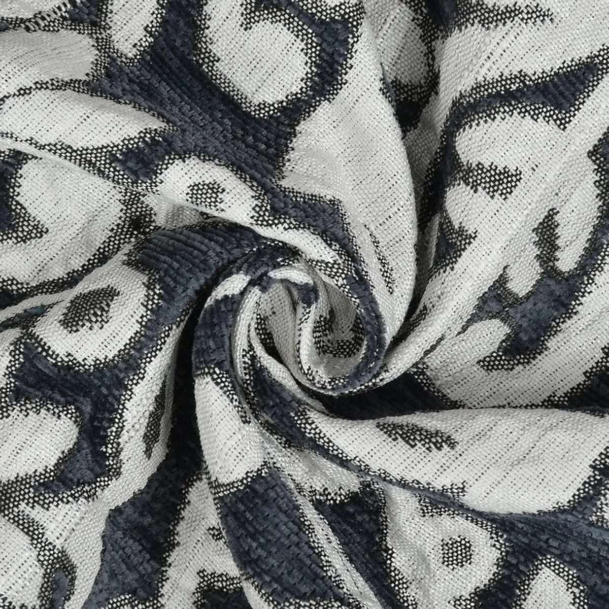 Close-up view of the table cover's textured floral fabric in grey and dark blue
