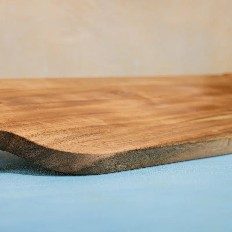 Close-up of the thick natural wood edge of a chopping board
