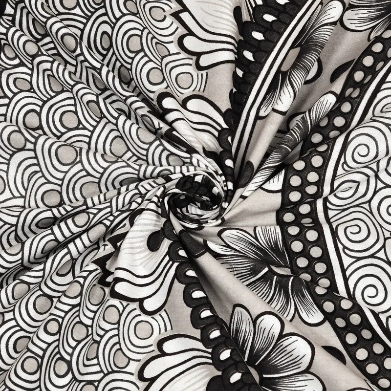 Close-up of black and white printed cotton fabric with swirling floral details