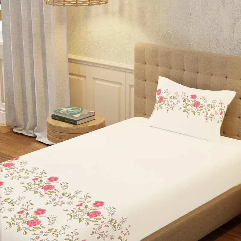 Close view of white bedsheet with pink floral print and matching pillow cover
