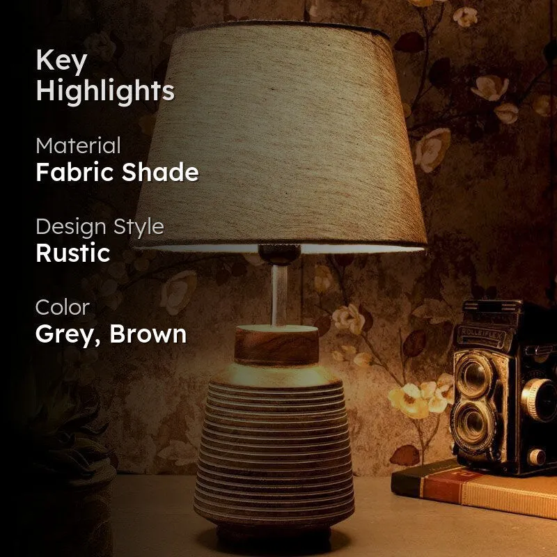 Table lamp with grey fabric shade and ridged brown base, highlight graphic