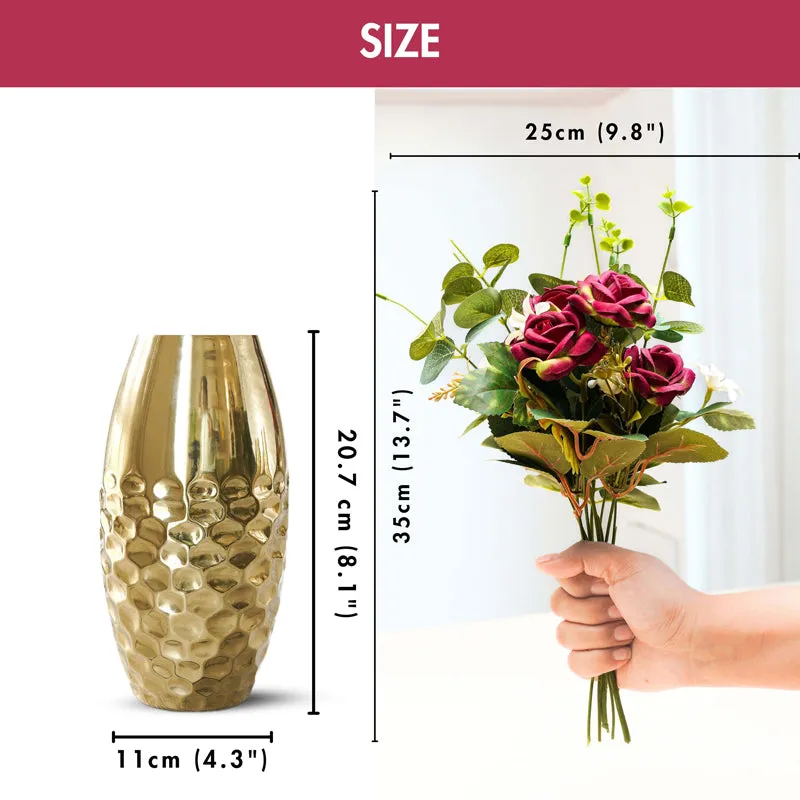 Gold textured vase beside the artificial rose bouquet