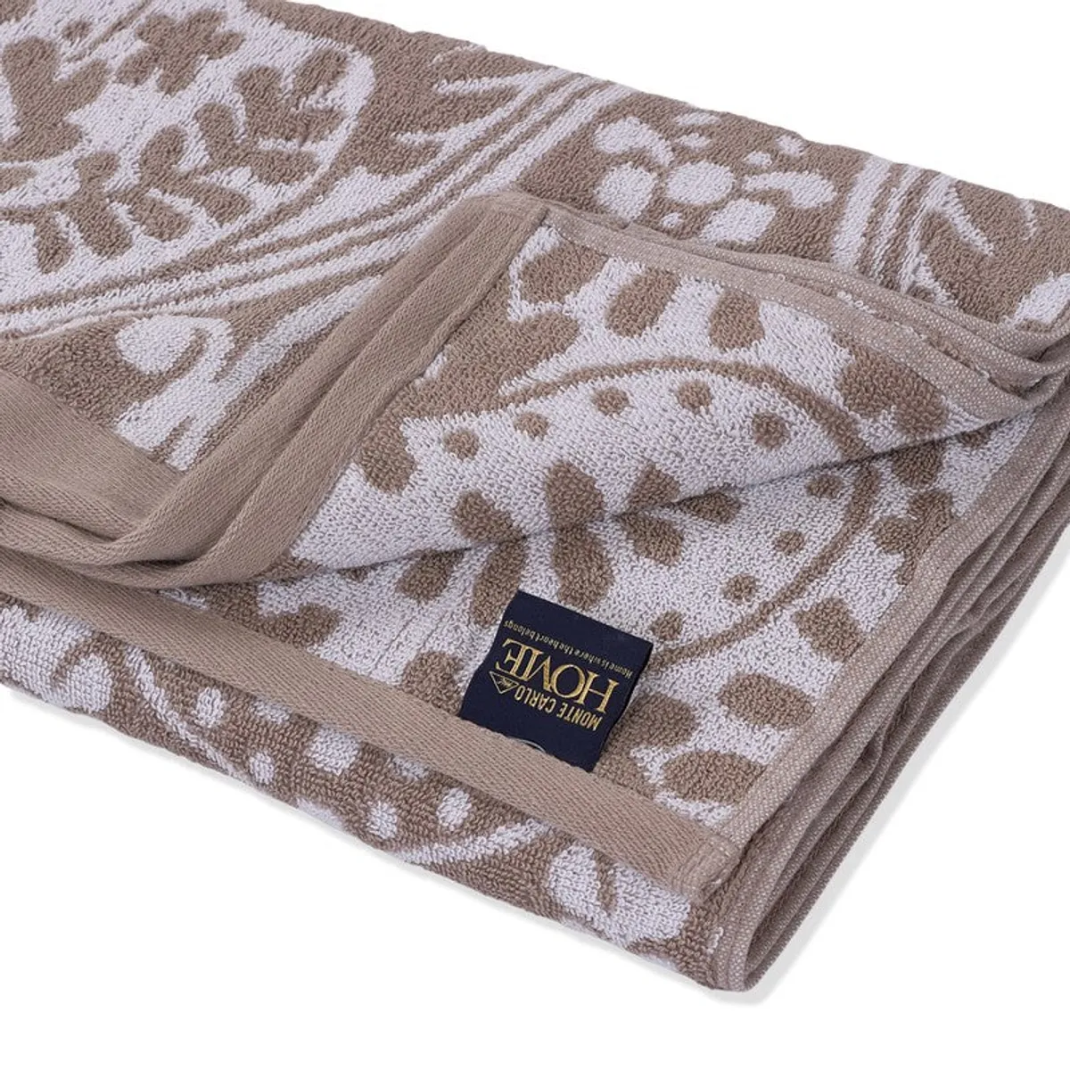 Close-up of the towel's floral textured surface and stitched edge