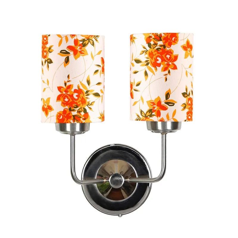 Studio view of wall lamp with two orange floral shades