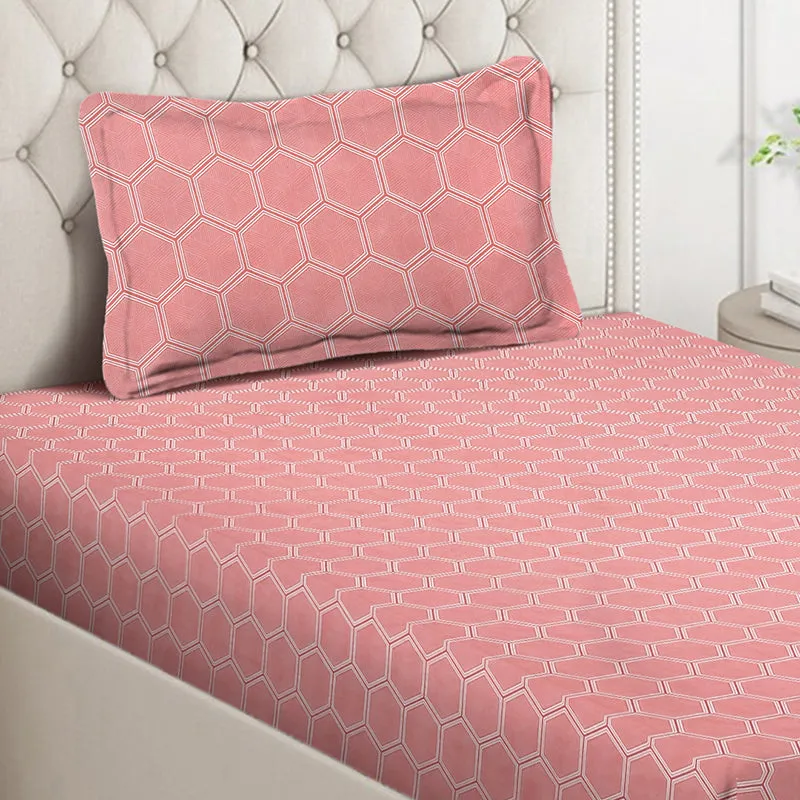 Close-up of pink hexagon-pattern bedsheet and pillow cover