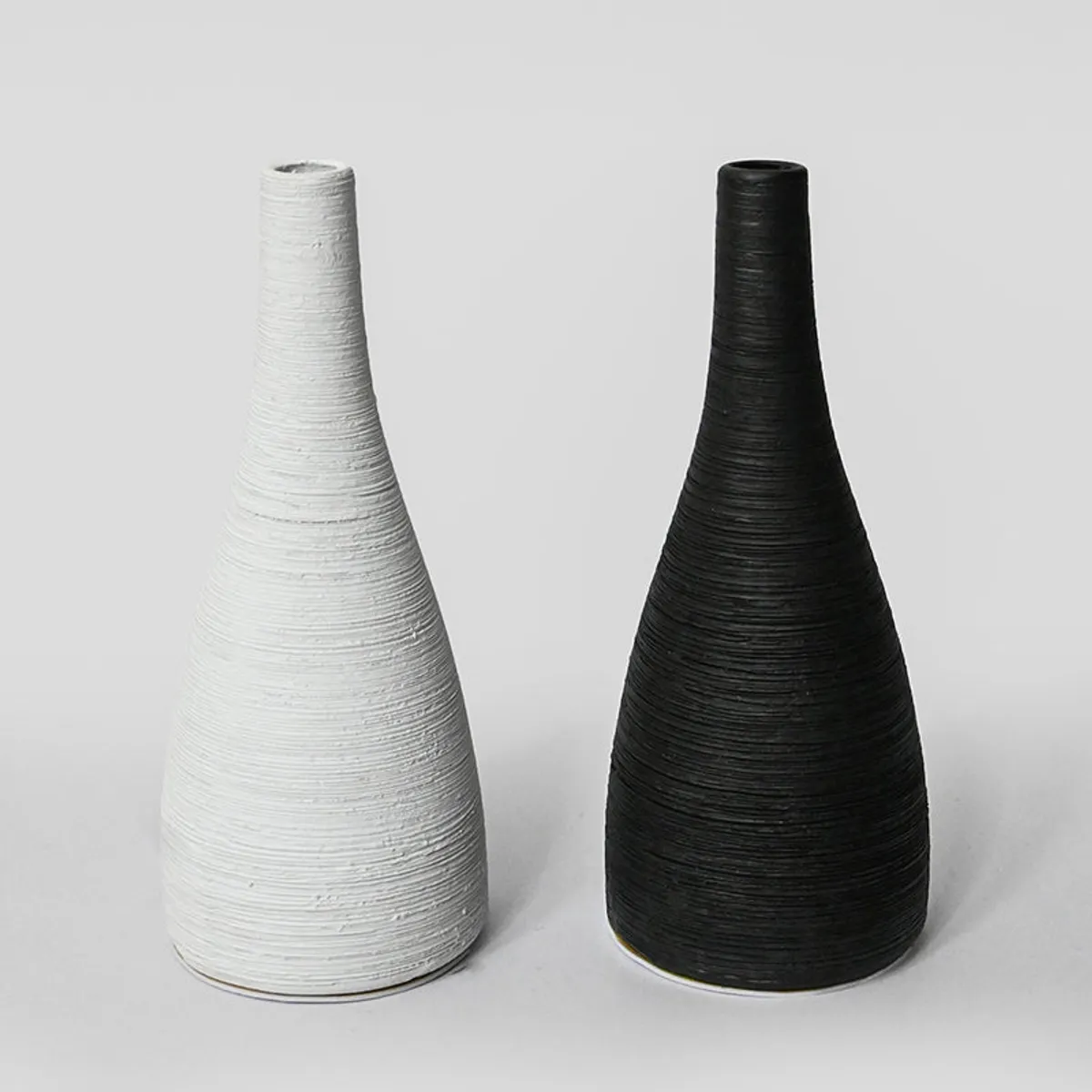 Black and white tapered vases shown side by side
